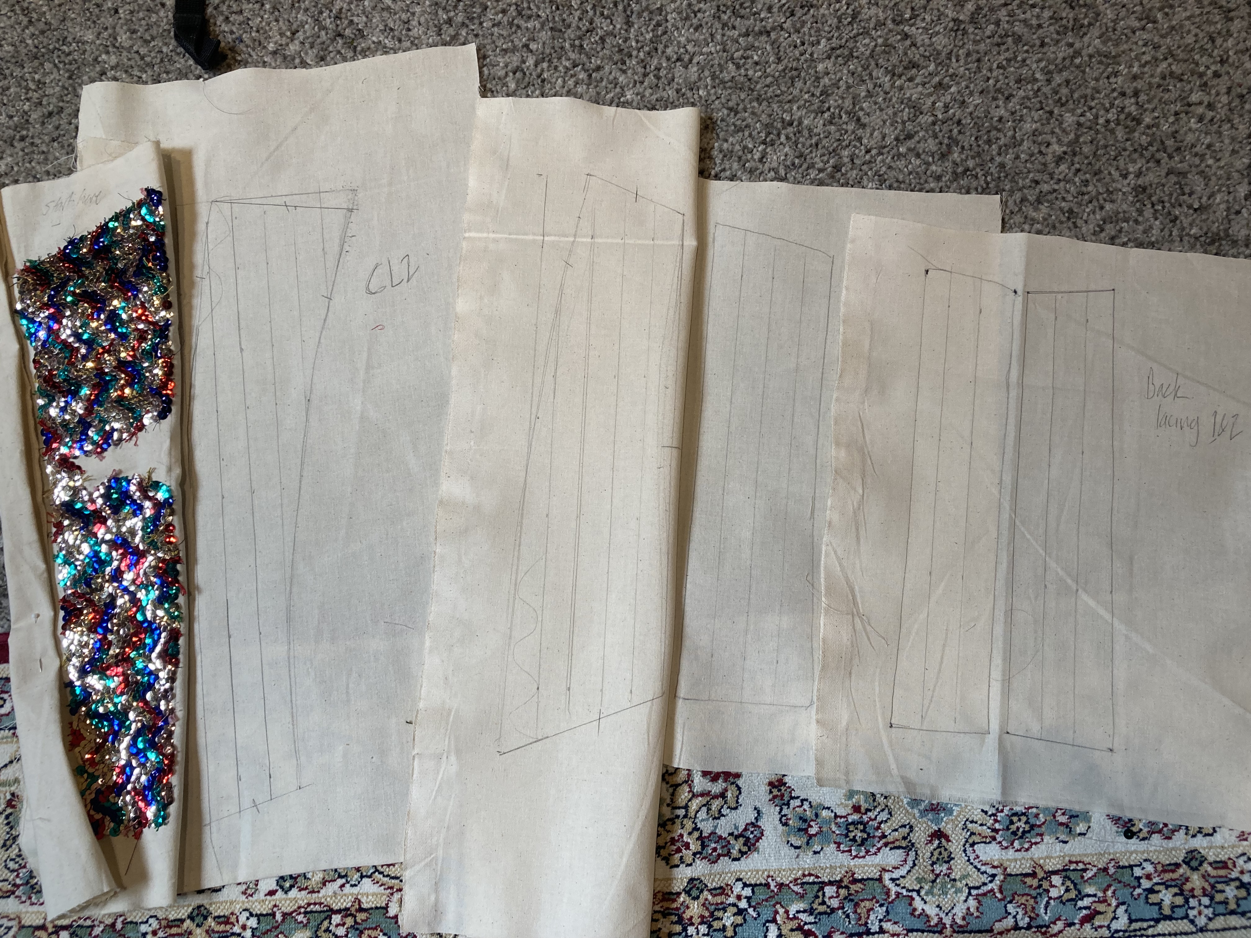 Panels of corset laid out before they are embroidered